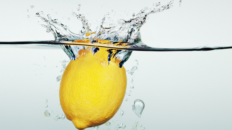 Lemon splashing into water