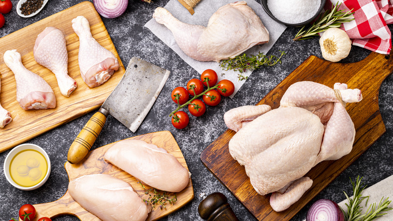 chicken pieces arranged with garlic and onions and herbs