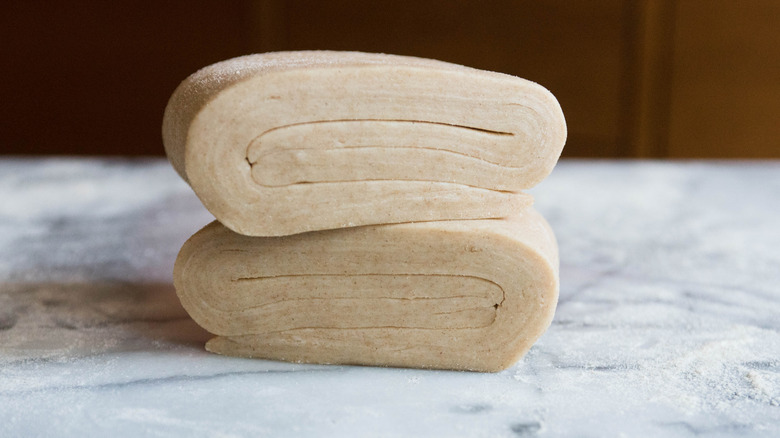 Two pieces of laminated dough stacked on top of each other