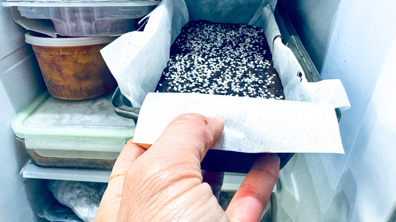 hand inside refrigerator 