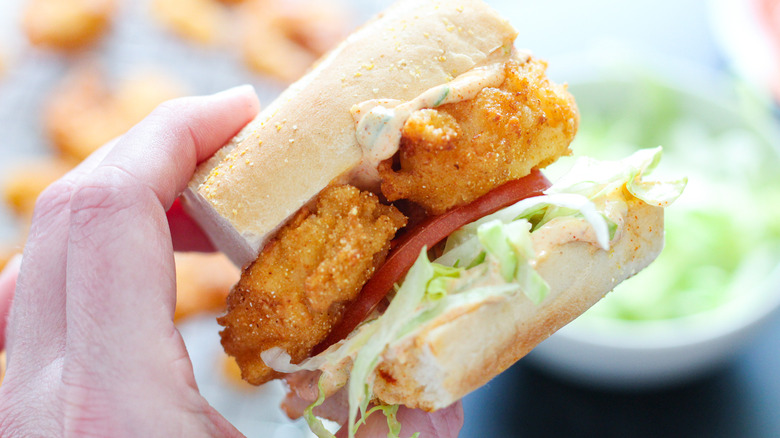 hand holding shrimp sandwich