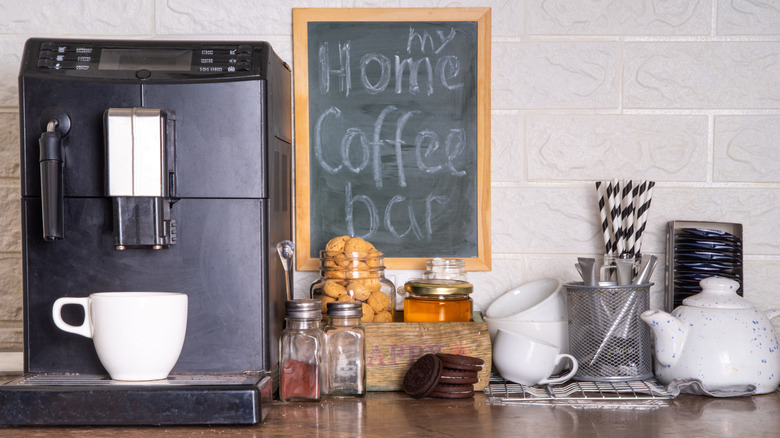 Home coffee bar with coffee machine, cookies, mugs, and more