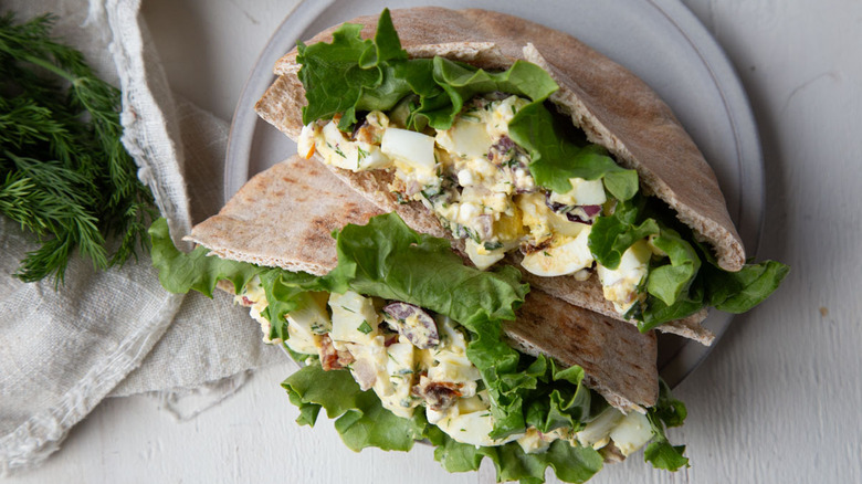 egg salad in pita bread on a white plate