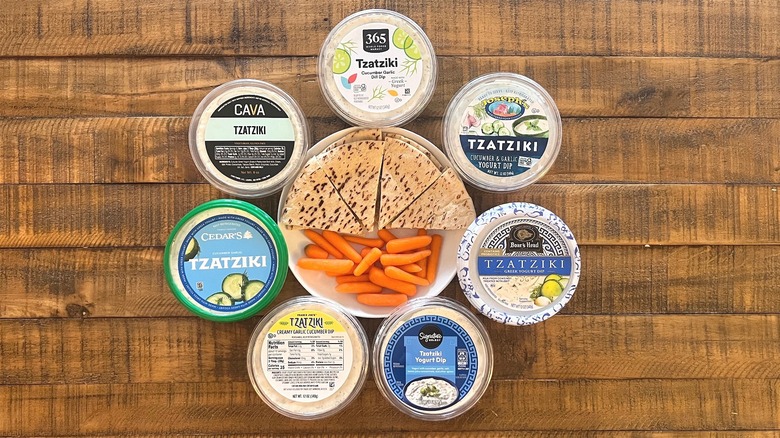 Variety of tzatziki brands with pita and carrots